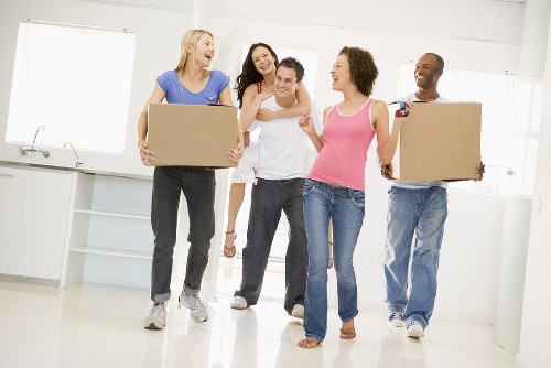 Removal team loading household items into a moving van