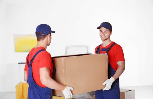 Professional movers handling a piano removal in Pimlico