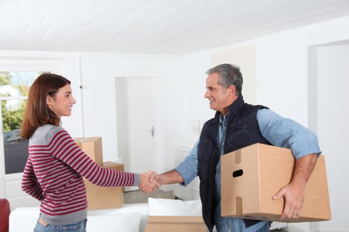 Professional movers handling packed boxes with care